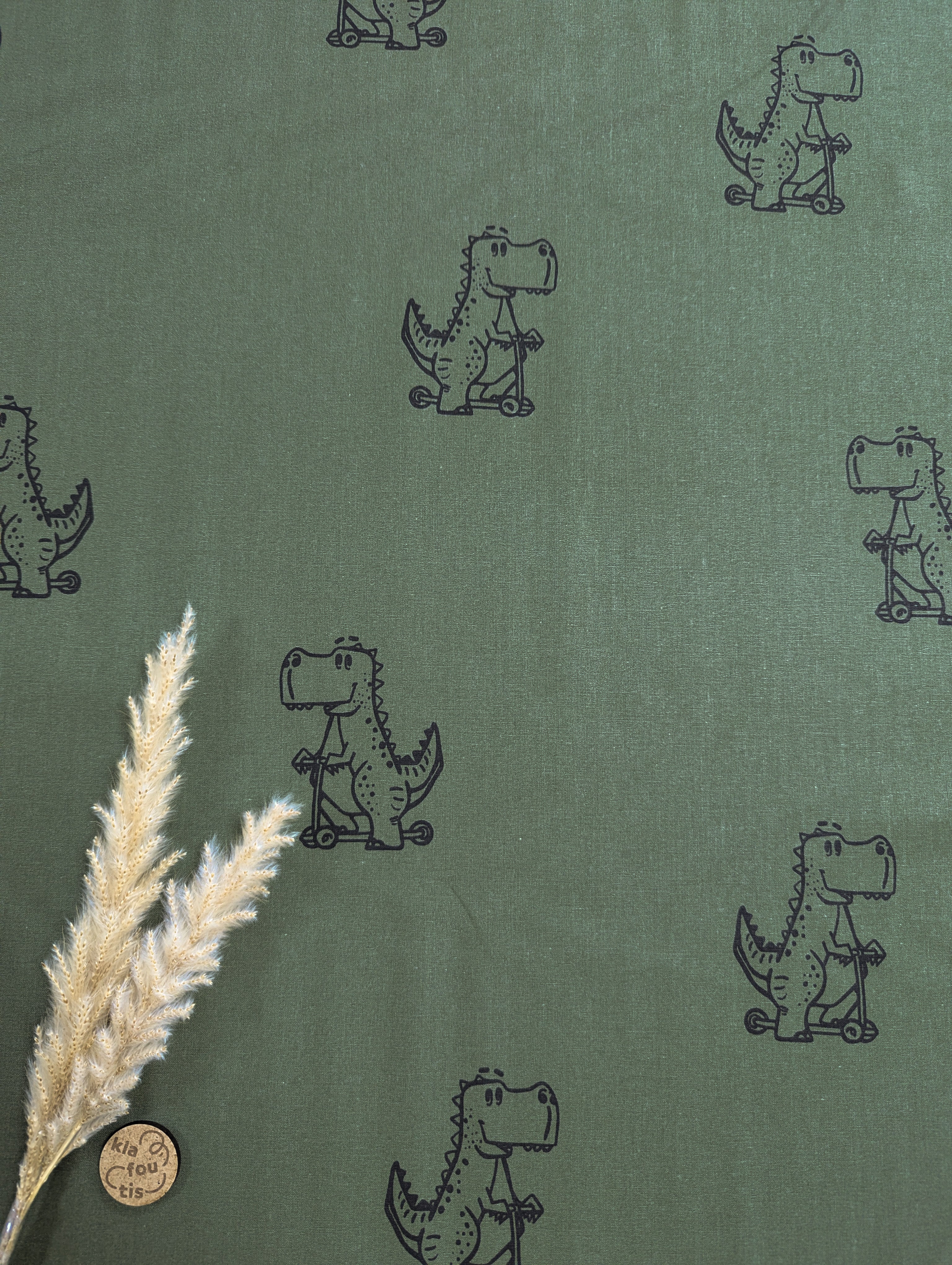 Popeline de coton kaki - dinos en trotinette